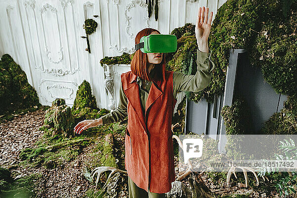 Redhead woman gesturing with virtual reality simulator