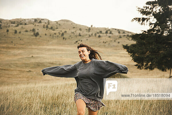 Cheerful woman running in Durmitor National Park
