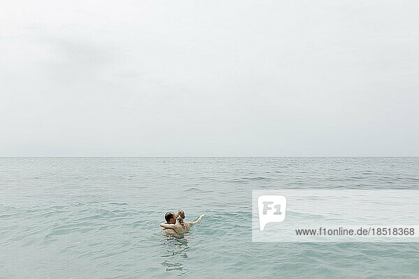 Couple swimming together in sea