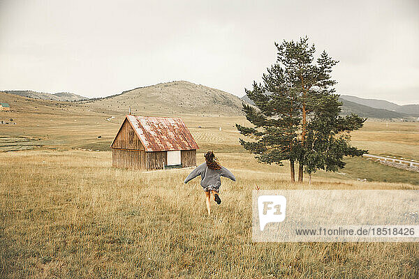Happy woman running in Durmitor National Park