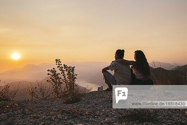 Couple sitting and enjoying sunset