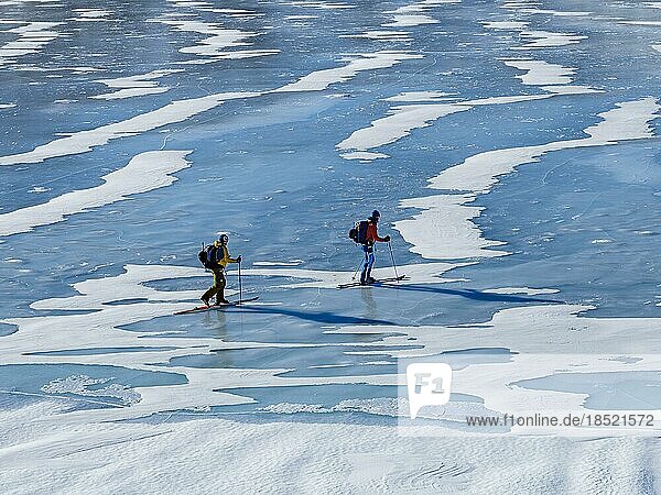 Ski mountaineers crossing a frozen lake  Tasiilaq  Ammassalik Island  Kommuneqarfik Sermersooq  East Greenland  Greenland  North America
