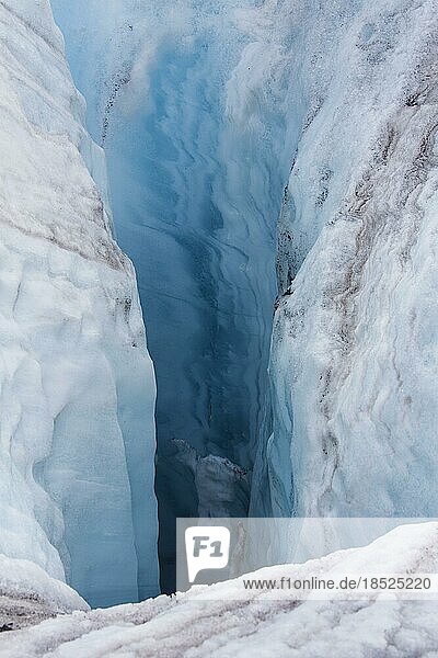 Crevasse in ice sheet of glacier caused by glacial meltwater