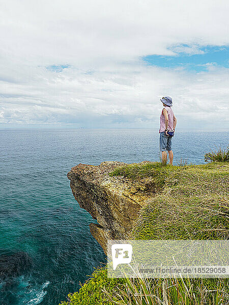 Australia  New South Wales  Port Macquarie  Woman standing on cliff and looking at view 