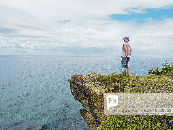 Australia  New South Wales  Port Macquarie  Woman standing on cliff and looking at view