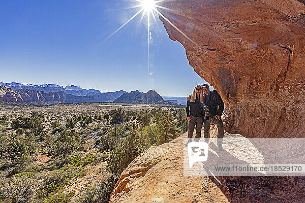 United States  Utah  Zion National Park  Senior couple standing on sandstone cliff