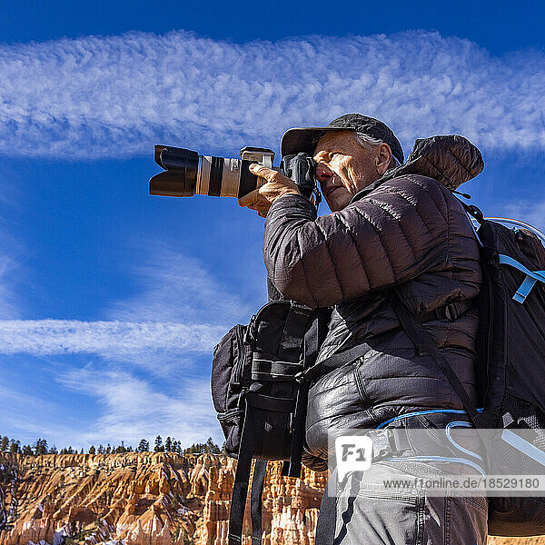 United States  Utah  Senior photographer photographing in Zion National Park