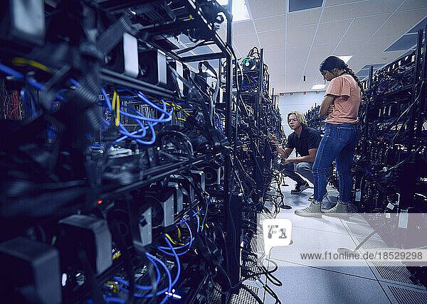 Technicians working in server room