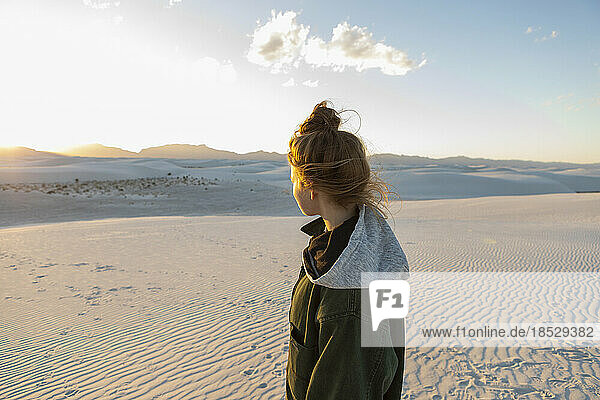 United States  New Mexico  White Sands National Park  Teenage girl looking at sunset