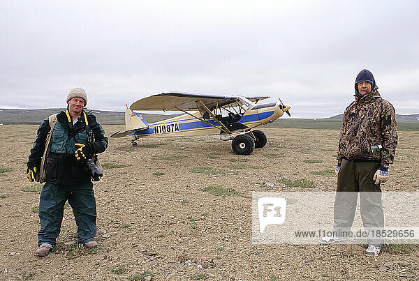Passenger and pilot in Alaska's North Slope area  USA; North Slope  Alaska  United States of America