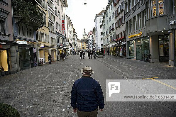 Senior man stands in the middle of a city street in Zurich  Switzerland; Zurich  Switzerland