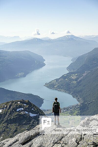 Hikers climbing to the top of Skåla  view of mountains and fjord Faleidfjorden  Loen  Norway  Europe