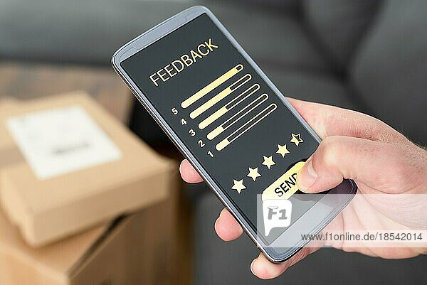 close-up of person giving positive feedback on smartphone after delivery of ordered items  customer review and feedback concept