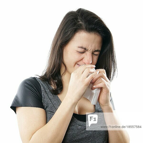 young woman blowing nose with paper tissue