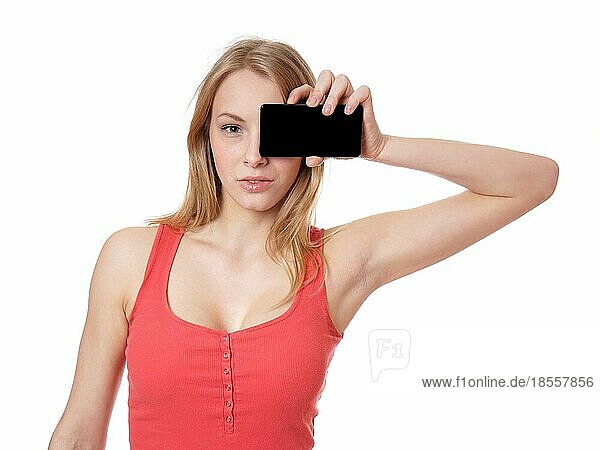 young woman holding smart phone camera with blank screen in front of eye