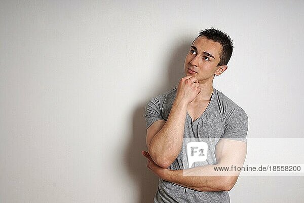 muscular young man contemplating an idea. with copy space
