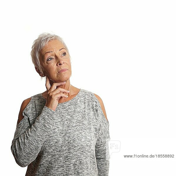 thoughtful concerned mature woman looking up. isolated on white
