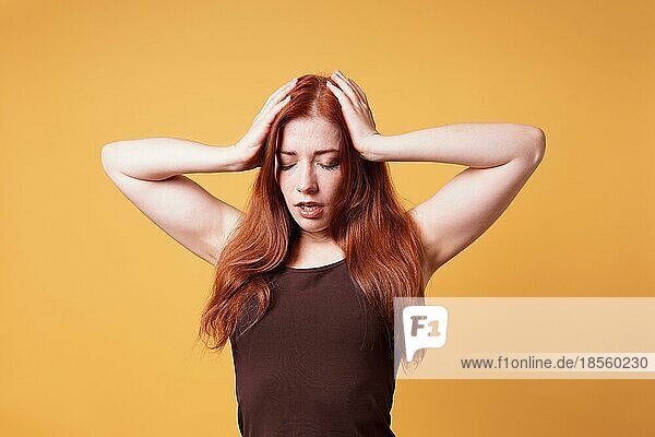 stressed exhausted young woman suffering from headache or nervous breakdown - girl holding head with eyes closed