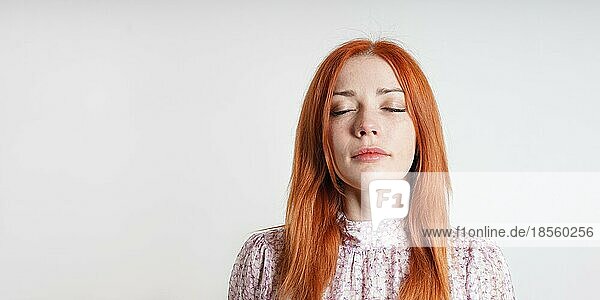 Calm friedliche Frau meditiert mit geschlossenen Augen - Introspektion Achtsamkeit Stressabbau und Selbstfürsorge Konzept - hellgrau Studio Hintergrund mit Kopie Raum