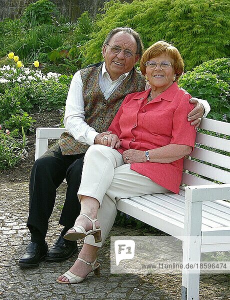 Older married couple in park  posing  portrait  friendly  smiling  Older married couple  posing  portrait  friendly  smiling