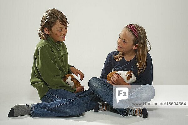 Boy and girl with guinea pig