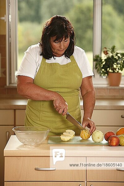Frau bereitet Obstsalat zu  Messer  schneiden  zubereiten  Schüssel