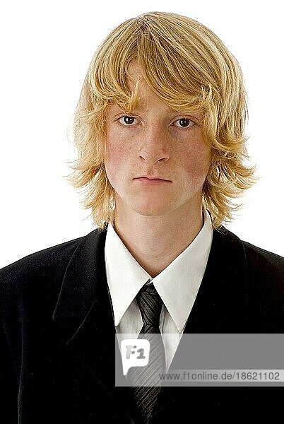 Blond boy with tie and suit looks serious  portrait