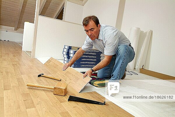 Man lays laminate flooring  renovate  lay laminate  DIY