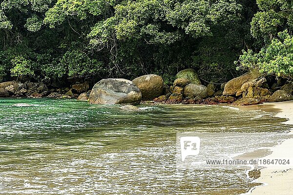 Beach in remote and deserted location in Trindade on the south coast of the state of Rio de Janeiro surrounded by rocks and the rainforest Brasil
