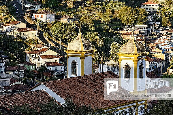 Türme und Glocken einer alten Barockkirche mit den Häusern der Stadt Ouro Preto im Hintergrund  Brasilien  Südamerika