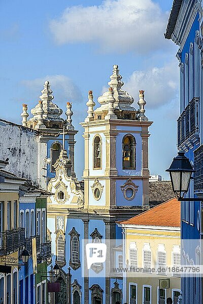 Alte Fassaden von bunten Häusern im Kolonialstil  Laternen und Fenster und ein Turm einer alten Barockkirche in Pelourinho  dem berühmten historischen Zentrum von Salvador  Bahia  Brasilien  Südamerika