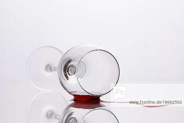 Red wine spilled out of fallen glass