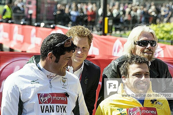 Prince Harry presents a medal to the Mens Elite Wheelchair winner Kurt Fearnley at the Virgin London Marathon Medal Presentations on 21.04.2013 at The Mall  London. Persons pictured: Prince Harry  Richard Branson  Kurt Fearnley