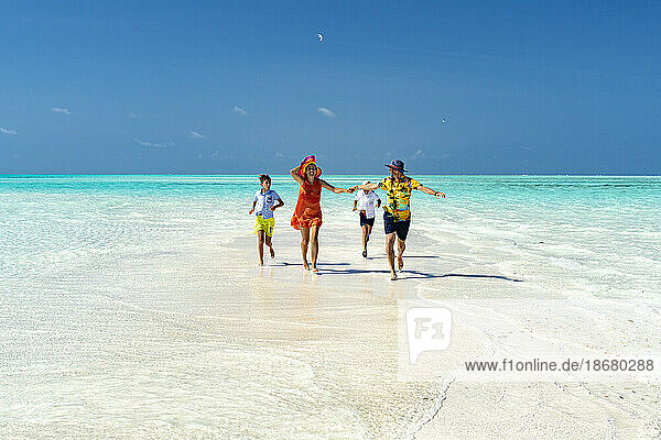 Family with two boys having fun running together on idyllic beach  Zanzibar  Tanzania  East Africa  Africa