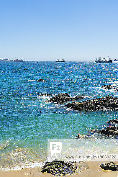 Rocky coastline and ships on sea  Caleta Abarca beach  Vina del Mar  Valparaiso Region  Chile  South America