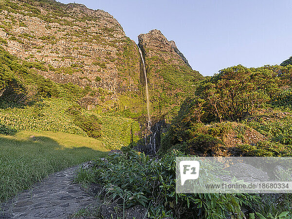Waterfall  Poco do Bacalhau  at sunset on Flores island  Azores Islands  Portugal  Atlantic Ocean  Europe