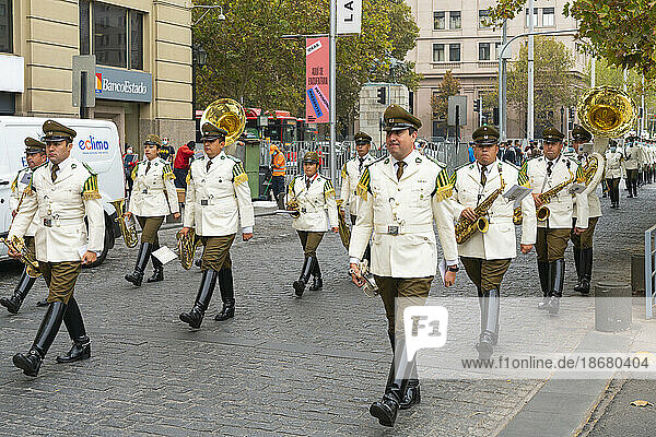 Policemen marching to La Moneda Palace for changing of guards ceremony  Santiago  Santiago Metropolitan Region  Chile  South America