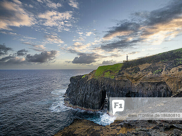 Cliff above the ocean  with a natural arch and small lighthouse  Farolim dos Fenais da Ajuda  Sao Miguel island  Azores islands  Portugal  Atlantic Ocean  Europe