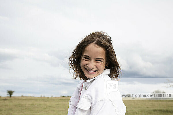 Portrait of smiling girl (10-11) in field