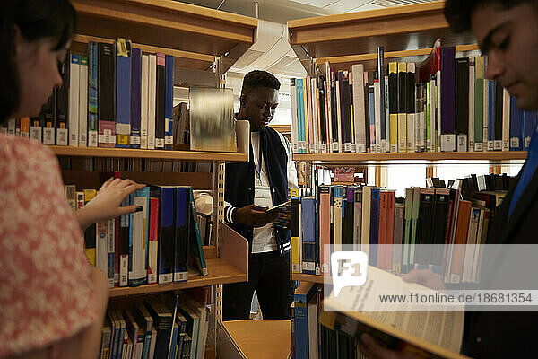 University students reading books in library
