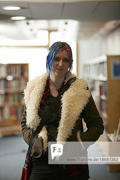 Portrait of student with colorful hair in library