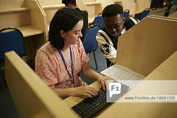 University students using computer in library