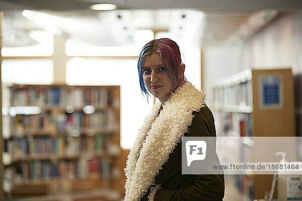 Portrait of student with colorful hair in library