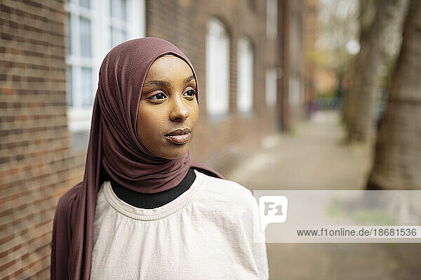 Young woman wearing hijab in street