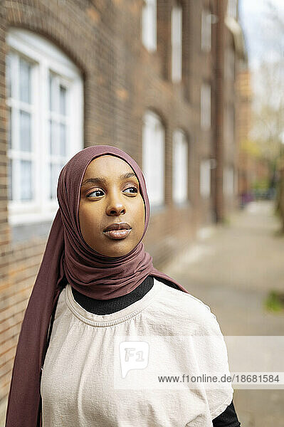 Young woman wearing hijab in street