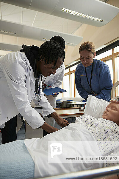 Medical students learning how to measure blood pressure