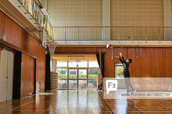 Japanese school kid playing basketball