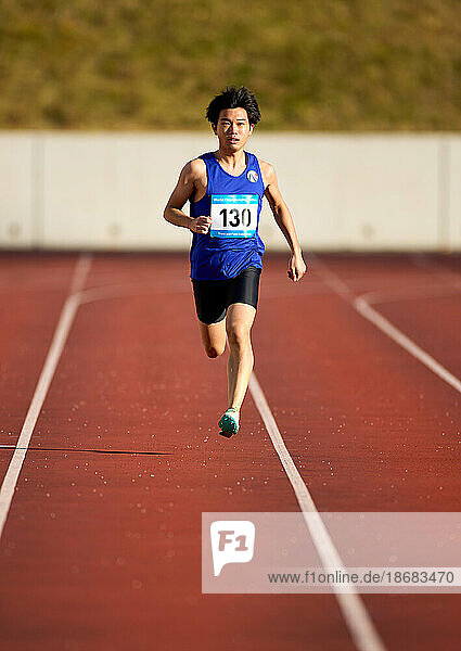 Japanese athletes running on track