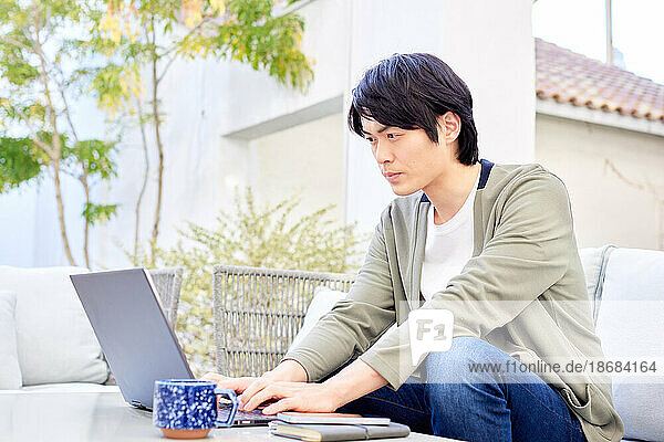 Japanese man working on laptop