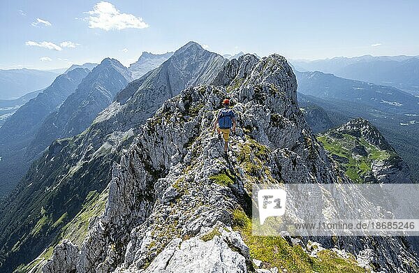 Climbers at the summit of the Upper Wettersteinspitze  view of the rocky ridge of the Wettersteingrat  Wetterstein Mountains  Bavarian Alps  Bavaria  Germany  Europe